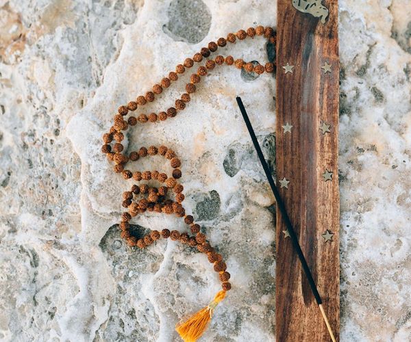 Silhouette of a person meditating at sunrise, symbolizing energy and vitality.